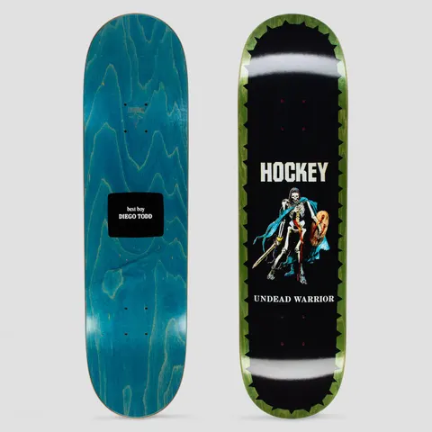 Hockey Diego Todd Undead Warrior skateboard deck: Skeleton warrior with sword, round shield and a blue cape on a black deck, edged with a green jagged border; brand name above and title below. The other deck is blue stain with a black label.