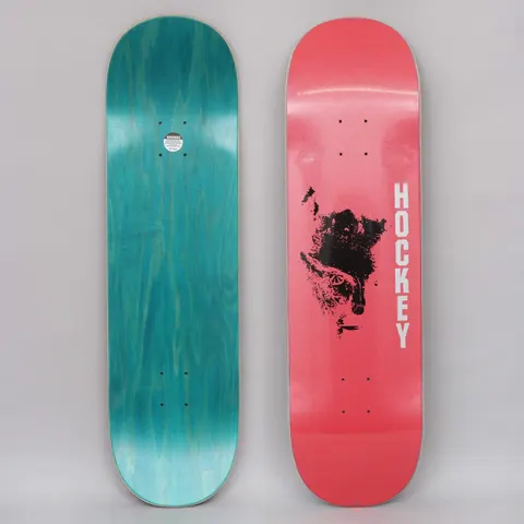 Hockey Chaos Red skateboard deck: Black smudged ink or print blot resembling a face, in the middle of a pink-red deck with vertical white HOCKEY lettering. Underside is teal stain.