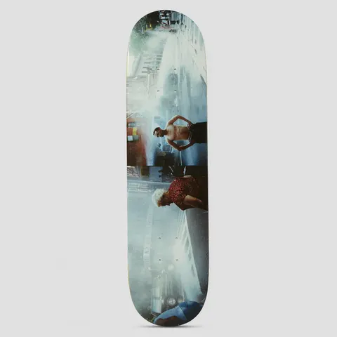 HUF Lost My Way Home Multi skateboard deck: Full-length photographic print of a wet city street scene, shown sideways along the deck: a shirtless man with raised arms, an older woman in a leopard-print top, a fire hydrant spray and parked cars.