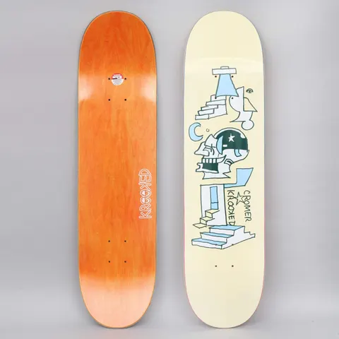 Krooked Cromer Half Moon skateboard deck: Line drawing of a skull wearing a green helmet with a star, between staircases, a crescent moon and an eye shape, on a cream deck. The underside is orange with Krooked written in white.