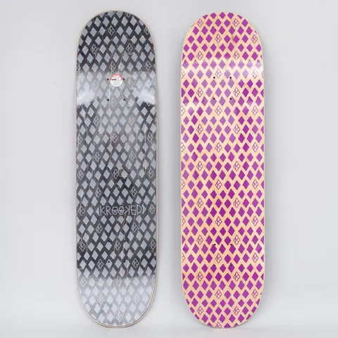 Krooked Dymonds Purple skateboard deck: Repeating all-over pattern of purple diamond shapes interspersed with small outlined Krooked eye logos on bare natural wood. The underside shows the same pattern in grey on a black stain, with a Krooked wordmark.