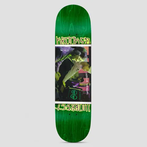 Krooked Worrest Struggual DBX Green/Purple skateboard deck: Green stained deck with a central tinted photo of two people working at music equipment in a studio, bordered above and below by yellow-green scrawled lettering. A small Krooked eyes logo sits in the photo, with handwritten text beside it.