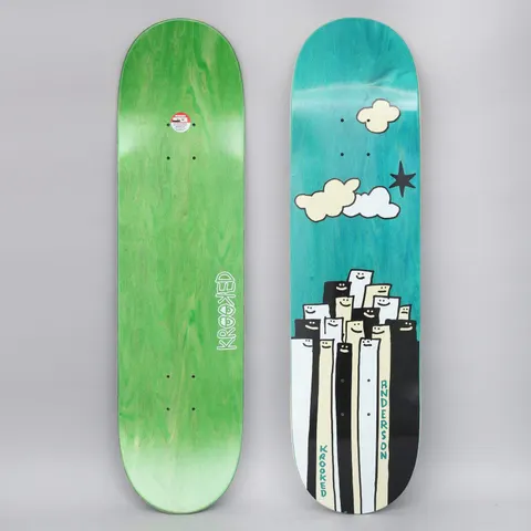 Krooked Anderson Gathering skateboard deck: A crowd of tall, narrow smiling figures in black, white and cream stands packed together under a teal sky with cartoon clouds and a black star. The photo shows the top and bottom of the deck, with a Krooked logo on the green underside.