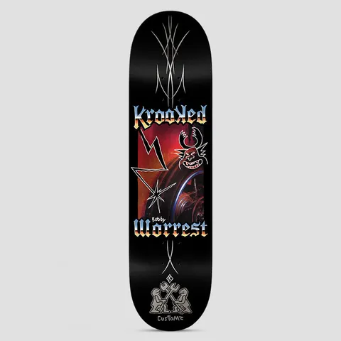 Krooked Worrest Chrome Zone Twin Tail Black skateboard deck: Chrome-gradient blackletter Krooked and Worrest lettering frames a red photo panel with a lightning bolt, a star burst and a doodled horned grinning demon face. Silver pinstripes run along the deck and two figures with wrenches sit at the tail.