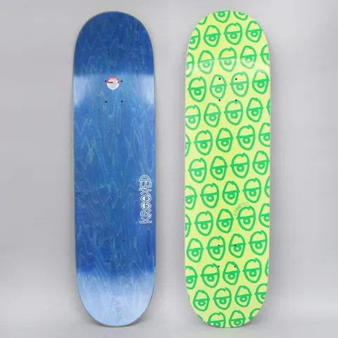 Krooked Pewpils Green skateboard deck: A repeating pattern of small green cartoon heads with single large eyes covers a lime green deck. The photo shows the top and a blue-stained underside with the Krooked logo.