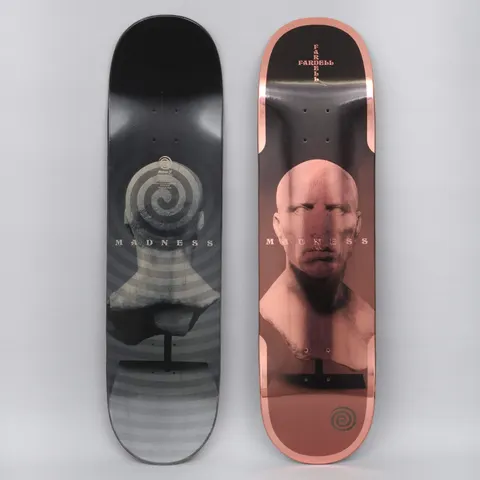 Madness Jack Fardell Trauma Bronze skateboard deck: Classical bust of a bald male head on a stand, with a spiral on the back of the head in the black version and a rose-copper metallic foil finish with a small spiral logo on the other. Photo shows two decks.