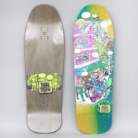 New Deal Howell Tricycle Kid Neon skateboard deck: A cartoon kid in a green cap and sneakers riding a tricycle past a pink building with windows and speech bubbles, with green slime and a stack of people above, on a green and yellow fade. New Deal logo at the tail.