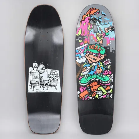 New Deal Howell Molotov Kid SP Black skateboard deck: A cartoon kid in a Deal cap and green boots lighting a petrol bomb on a pile of bricks, with a burning city and a falling skater behind. The underside shows a black and white cartoon of a man in an armchair.