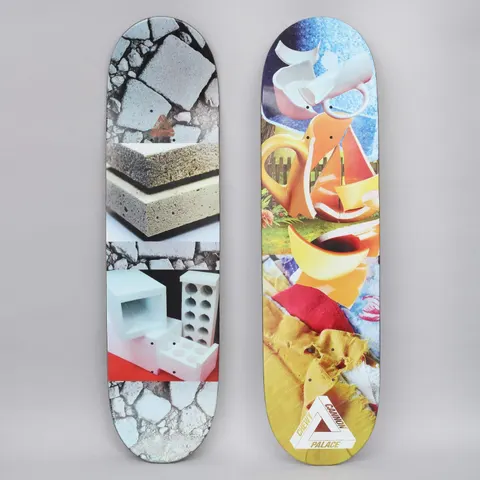 Palace Chewy Pro S21 skateboard deck: Surreal collage of photos: a smashed orange and white teapot or jug over a garden fence, crumpled yellow and red fabric, and cracked paving with foam blocks and breeze blocks. Palace triangle logo with Chewy Cannon at the bottom.