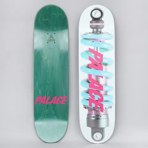 Palace Shock White / Pink skateboard deck: White deck showing a photographic shock absorber with a pale blue coil spring, with the Palace name in slanted pink capitals across it. The underside, green with pink Palace text, is shown alongside.