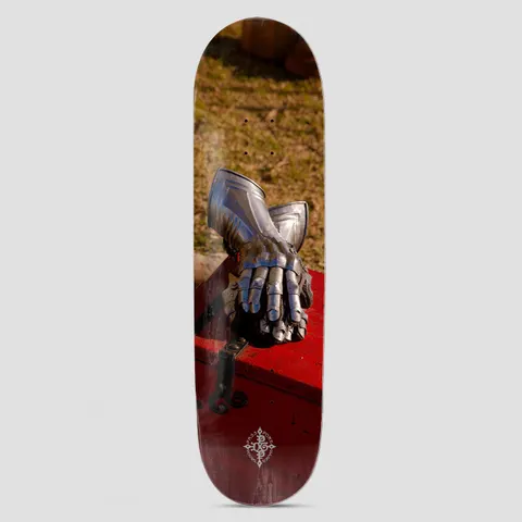 Passport D.G Series Gauntlets skateboard deck: Full-bleed photograph of a pair of steel armour gauntlets resting on a red wooden chest on dry grass. A small ornate Passport emblem sits at the bottom.