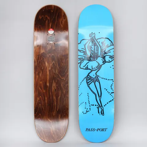 Passport Floral Dancer Hibiscus Blue skateboard deck: Black line drawing of a dancer with a hibiscus flower as her skirt, standing on pointe with dotted arcs around her, on a bright blue deck. Brand name in serif capitals at the foot. Brown wood underside shown beside it.