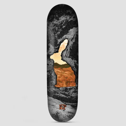 Passport PassPort Cave~in Series Jack Rabbit skateboard deck: A rabbit-shaped opening in a stippled black and white cave wall reveals a sunlit orange desert landscape with hills, with a small logo at the bottom.
