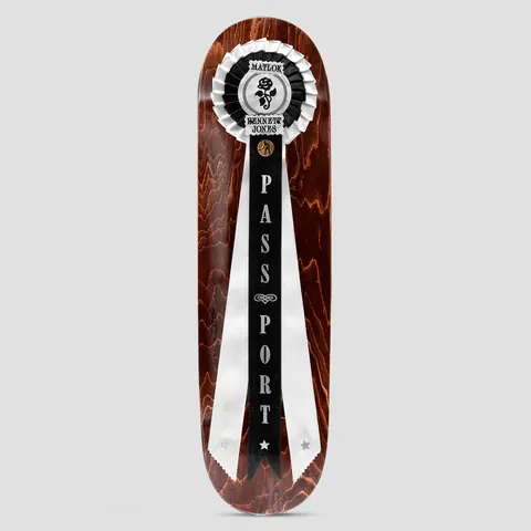 Passport Rosette Series Matlok skateboard deck: Red-brown stained wood deck with a prize rosette at the nose in black and white, a black ribbon reading PASSPORT down the centre and two long white tails. Rosette text names Matlok Bennett Jones.