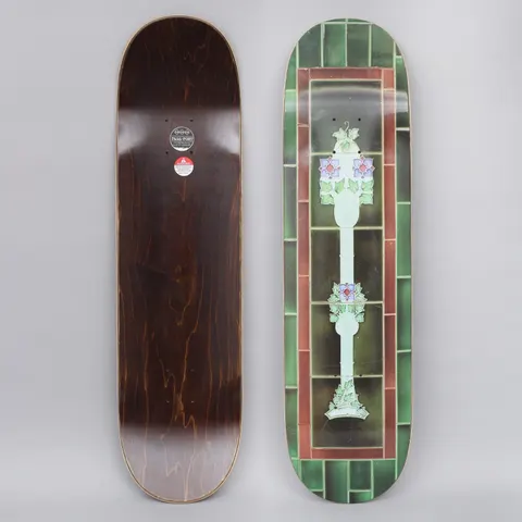 Passport Tile Life Green skateboard deck: A Victorian-style stained-glass lamp post with purple flowers and green leaves, centred in a panel of dark green and maroon ceramic tiles that frame the whole deck.