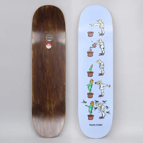 Passport W.C.W.B.F? Grow Lilac skateboard deck: Lilac deck with a five-step comic strip of a man in white tipping out a pot, watering it, growing a flower woman, then being swarmed by flies as the plant becomes a green woman. 'PASS-PORT' is printed at the tail.