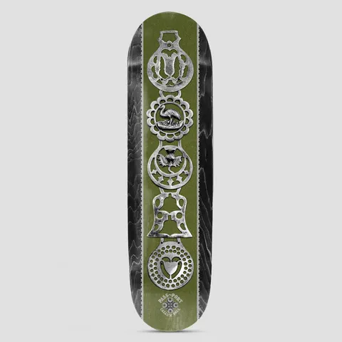 Passport Brasses Pro Series Callum skateboard deck: Photographic stack of five silver horse brasses, including a bird, a bell and a heart, down a green central panel with black wood-grain edges. Pass~Port and the rider's name appear in a small logo at the bottom.