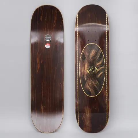 Passport Inlay Brown skateboard deck: Dark brown wood-stained deck with an oval panel of swirling wood-grain veneer pattern and gold PP monogram, edged with a gold rope-style border running down both sides.