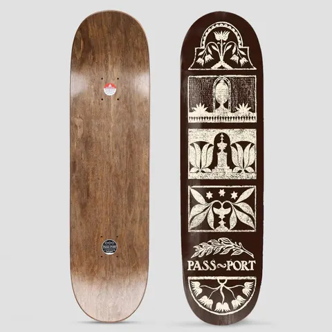 Passport Rubbings Series Back Yard skateboard deck: Cream block-print style panels on a dark brown deck, stacked down the board and showing tulips, leaves, a fountain, an urn and stars, with a laurel sprig above the Pass~Port name. The photo also shows the wood underside.