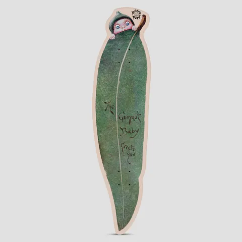 Passport x May Gibbs 8.0 Gum Leaf Cruiser skateboard deck: Deck cut in the shape of a long green gum leaf, with a vintage illustration of a baby in a leaf cap peeking over the top and handwritten words down the leaf.
