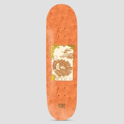 Passport x May Gibbs 8.125 Wattle Baby skateboard deck: Orange deck with a tone-on-tone floral pattern and a cream central panel showing a vintage storybook illustration of gumnut babies on a leaf with wattle blossom and a mosquito. Small Passport logo at the bottom.