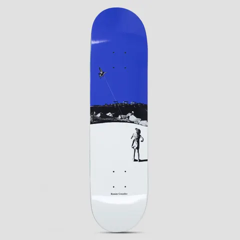Polar Roman Gonzalez Kite Blue skateboard deck: A black and white photograph of a girl in a hat flying a kite shaped like a bird, with a rocky hillside behind, set against a solid blue sky block at the top and white foreground. The rider's name is in small type at the bottom.