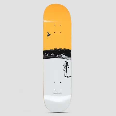 Polar Roman Gonzalez Kite Yellow skateboard deck: A black and white photo collage of a child flying a kite over a rocky shoreline, set against a flat orange upper half and white lower half. Small name at the bottom.