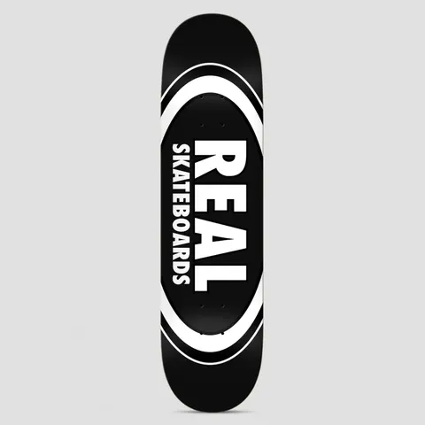 Real Team Classic Oval Black skateboard deck: Black deck with a large white oval logo, outlined in concentric rings, containing REAL in big white capitals with Skateboards in smaller capitals alongside.