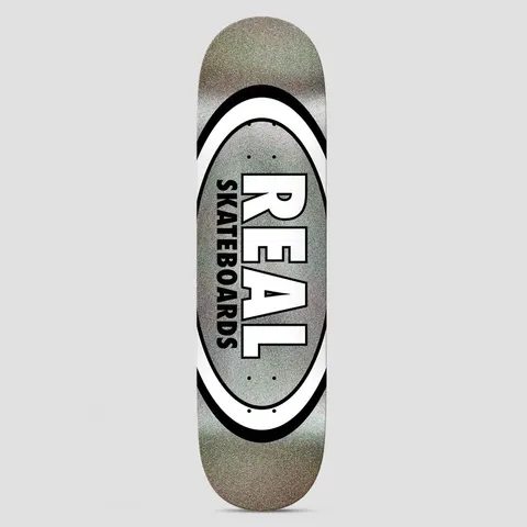 Real Team Classic Oval Easy Rider Black Holo skateboard deck: Real's classic oval logo with a white and black double ring around a grey holographic glitter centre. Large white 'REAL' with black outline sits above vertical 'SKATEBOARDS' inside the oval.