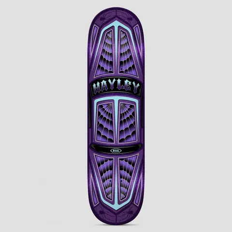 Real Hayley Threadline True Fit skateboard deck: Top-down view of a lowrider-style car body in purple glitter, with spider-web patterns in the windows and pale turquoise trim. A black plaque in the centre carries gothic lettering, and small spiders sit at both ends.