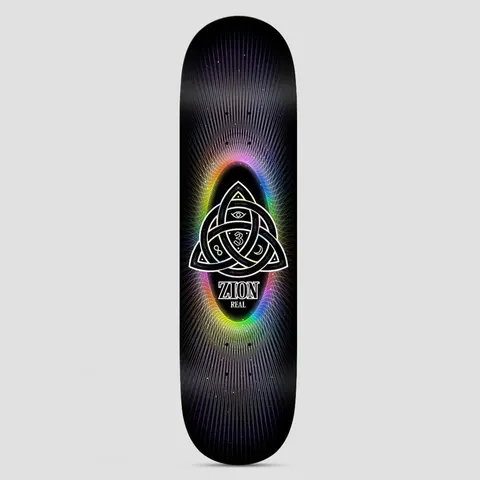 Real Zion Power Of Threes Easy Rider Black skateboard deck: Interlocking triquetra knot containing an eye, a 3 and a crescent moon, glowing in a rainbow gradient oval with fine radiating lines, on black. Zion and Real printed beneath.