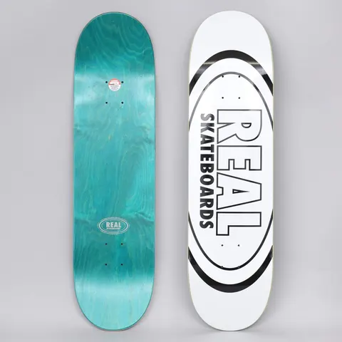 Real Classic Oval White skateboard deck: White deck with the Real logo, REAL SKATEBOARDS in black outlined block letters inside a large black oval. The photo also shows the teal underside with a small Real oval logo.