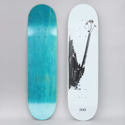 Sour Gustav Love Gun White skateboard deck: Grainy black and white photograph of a dockside or industrial structure with a long chimney-like pole, from which a bunch of daisies sprouts, on a pale blue-white deck. SOUR printed at the foot. Teal underside shown.