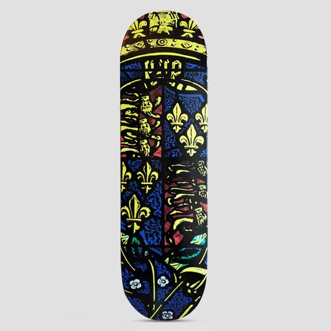 Thames MMXX Thames 9.0 Galahad II skateboard deck: Stained-glass style design in deep blue, red and yellow showing a heraldic shield with golden fleur-de-lis and lions, topped by a crown, with small white flowers in the foliage background.