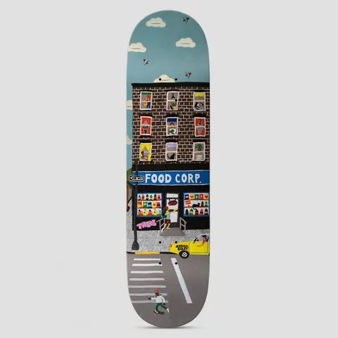 There Jessyka Bev Break Multi skateboard deck: Felt-collage street scene of a brick apartment block over a Food Corp shop, with people in the windows, a yellow taxi, a zebra crossing and a skater at the bottom, under a blue sky with birds.