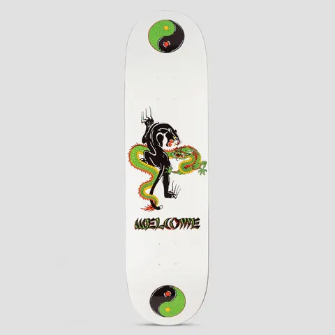 Welcome Opps Popsicle White skateboard deck: A black panther clawing down a coiled green and yellow dragon, drawn in tattoo style on a white deck. Welcome lettering in a warped font sits beneath, with a green yin-yang circle at each end.