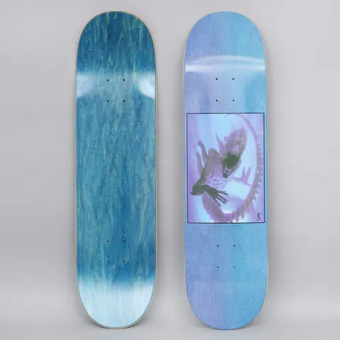 Yardsale Evolution A Blue skateboard deck: Framed square image in a speckled blue-purple deck showing a ghostly translucent alien creature with an elongated head and claws curling within a ring of ribs, in violet and green tones. Small signature mark beside it.