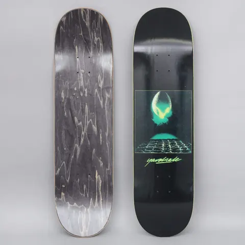 Yardsale Genesis Black skateboard deck: Black deck with a central framed image of a glowing green alien egg splitting open above a grid-patterned surface, in a sci-fi film-poster style. Green handwritten-style 'yardsale' logo underneath.