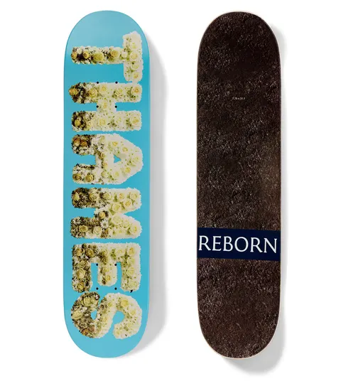 Thames MMXX Reborn Hobnob skateboard deck: Brand name spelled out in white and cream flowers, in blocky capitals on a bright blue deck. The underside is a dark brown fur or carpet texture with a navy label reading Reborn.