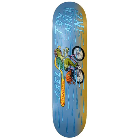 Toy Machine Axel Cruysberghs Cyclist 8.25 skateboard deck: A green turtle in a pink helmet rides a pink bicycle, with an orange one-eyed monster beneath, through blue rain on a blue and ochre deck. Dripping blue lettering for the brand and rider name, and Crusher on a yellow banner.