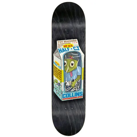 Toy Machine Cj Collins Toy Dolls 8.38 skateboard deck: Milk carton parody with a green zombie-like creature and skeleton hands sealed in a window, with joke packaging text on the sides. Carton sits on a black stained deck.