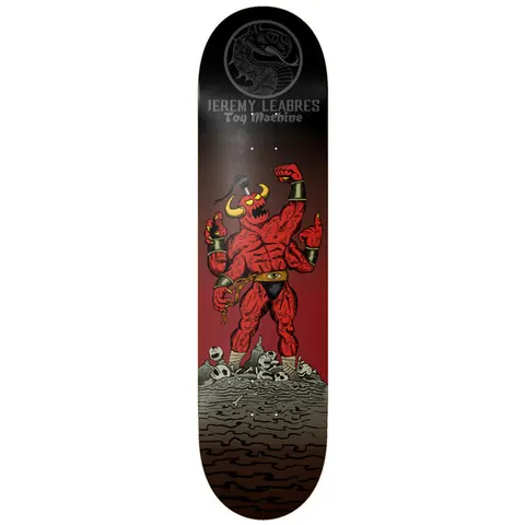 Toy Machine Jeremy Leabres Death Fight 8.25 skateboard deck: Muscular red four-armed horned demon flexing on a pile of skulls, with a dragon medallion and Jeremy Leabres Toy Machine lettering at the top, on a black to red fade.