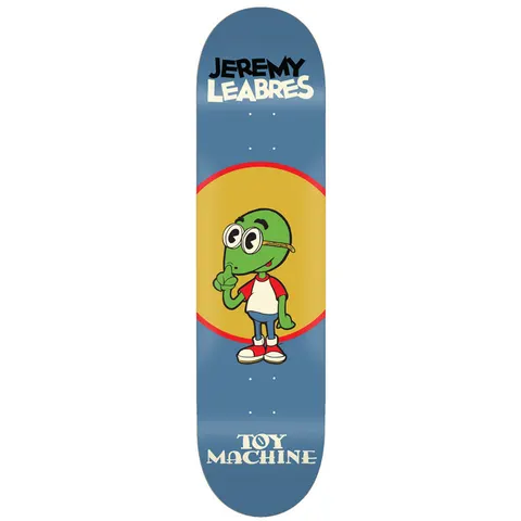 Toy Machine Jeremy Leabres Toons 8.50 skateboard deck: Cartoon green turtle-like character with big round glasses in a white and red shirt, raising a finger to his nose, in front of a yellow circle with red ring on a blue deck. Name at top, Toy Machine below.
