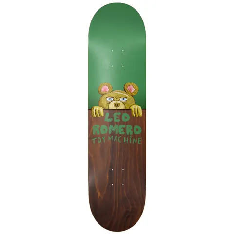 Toy Machine Leo Romero Fence 8.13 skateboard deck: Crudely painted teddy bear peeks over a fence, with hand-lettered rider and brand names on the lower wood-stained half. Top half is flat green.