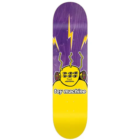 Toy Machine Transmissionator 8.50 skateboard deck: A yellow multi-eyed alien-like character with three antennae and side speakers, with yellow lightning bolts above, on a purple deck whose lower half is solid yellow, with the brand name in a white label.