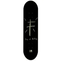 Foundation KOR Gold Foil skateboard deck: Rough hand-drawn grey cross shape with short radiating lines above handwritten text on a black deck, with a small logo at the base.