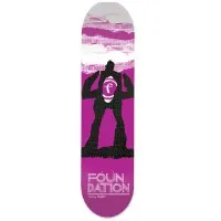 Foundation Duffel Heroes Fiberlam skateboard deck: Black silhouette of a giant figure with arms raised, holding a Foundation 'f' emblem in its chest, on a purple and grey torn-paper background. Foundation lettering at the base.