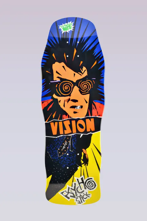 Vision Street Wear Psycho Stick - Modern Concave - Blue/Yellow skateboard deck: A spiky-haired figure with orange skin and spiral glasses and a gritted-teeth grin, over a torn Vision band, with a dark patterned suit below. Blue and yellow panels with burst lines, and a Psycho Stick scrawl at the tail.