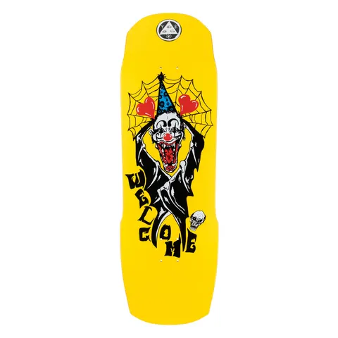 Welcome Crazy Tony on Totem 2.0 - Neon Yellow - 9.75 skateboard deck: A fanged clown in a blue party hat and black robe holding up heart balloons in front of a spider web, with a small skull beside. The Welcome name is lettered down the lower deck, on a yellow shaped deck with a round logo at the nose.
