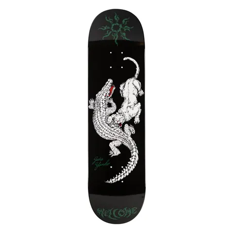 Welcome Jake Yanko Swamp Fight on Popsicle - White/Black - 8.5 skateboard deck: A white line-drawn crocodile and big cat locked in a fight on a black deck, with a green tribal sun at the nose, a green Jake Yanko signature and Welcome in gothic lettering at the tail.